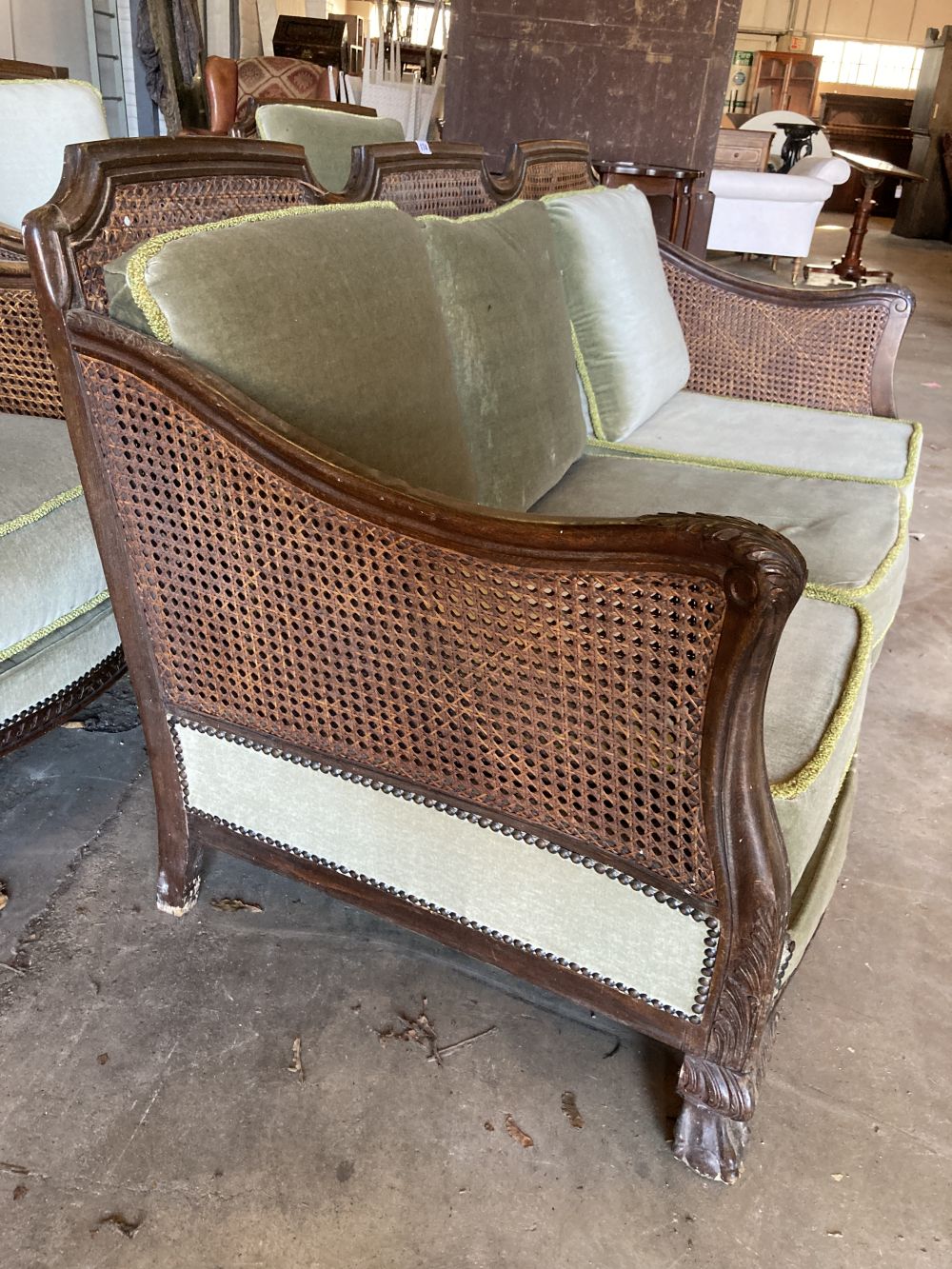 A 1920s carved beech four piece bergere suite